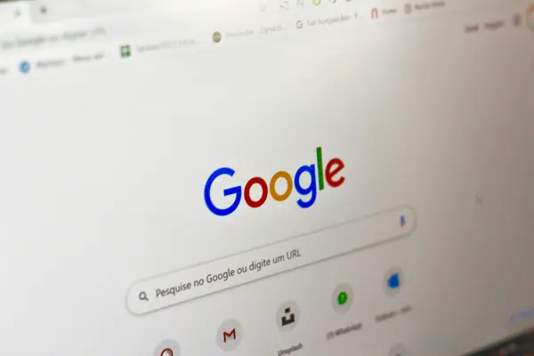 Close-up of Google homepage and search bar on a laptop screen