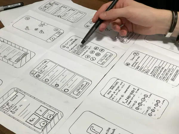 Hand sketching wireframes on paper — design and layout planning for a website redesign